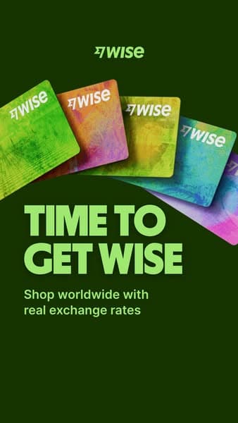 A dark green banner with colorful Wise cards fanned out at the top; the headline reads "TIME TO GET WISE" and below it says "Shop worldwide with real exchange rates.