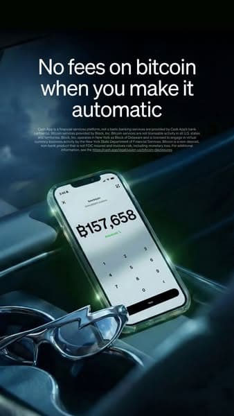 A dark-themed banner with an image of a smartphone displaying a Bitcoin amount, partially covered sunglasses in the foreground, and the headline text "No fees on bitcoin when you make it automatic" clearly visible above the phone; no CTA is visible.