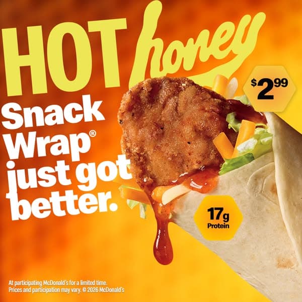 A McDonald's banner with a warm orange background prominently features a hot honey Snack Wrap with dripping sauce; bold text reads "HOT honey Snack Wrap just got better." and highlights a price of $2.99 and 17g Protein.