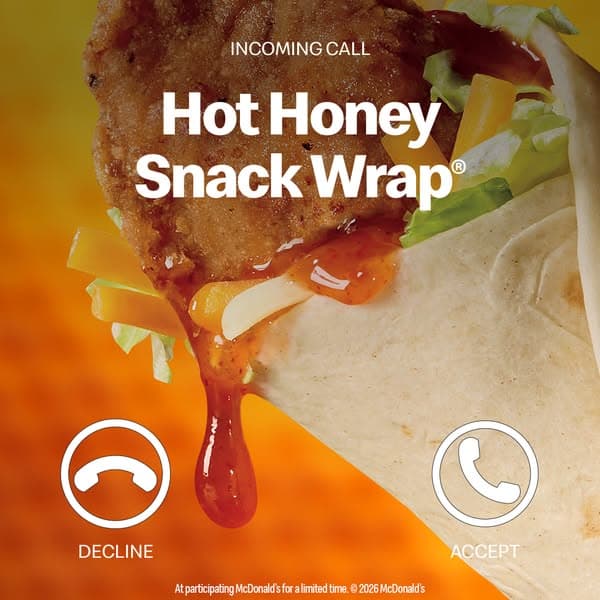 Close-up image of a McDonald's Hot Honey Snack Wrap with honey dripping, orange-yellow background, and phone call icons labeled "DECLINE" and "ACCEPT," with text reading "INCOMING CALL Hot Honey Snack Wrap" and partially unreadable small print below.