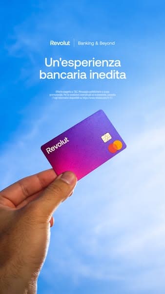 A hand holds a purple and pink Revolut card against a blue sky background with white text reading "Un'esperienza bancaria inedita" and smaller partially unreadable text below; the headline translates to "A unique banking experience.